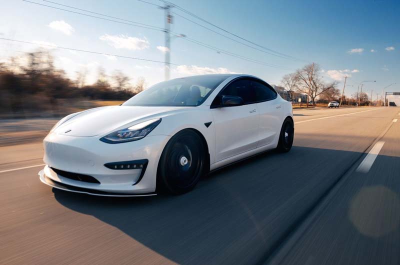 Do-Miles-Really-Matter-on-a-Tesla. Pimped out White Tesla on the road