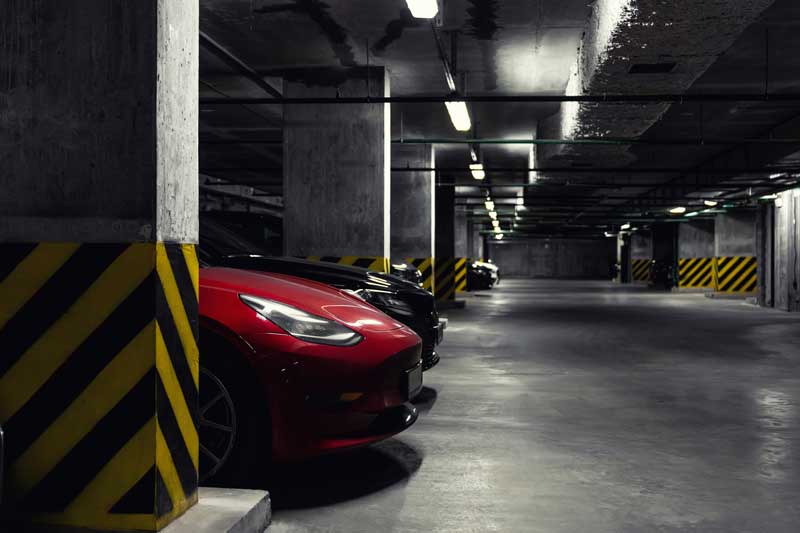 Electric Vehicles In A Dark Underground Parking Lot