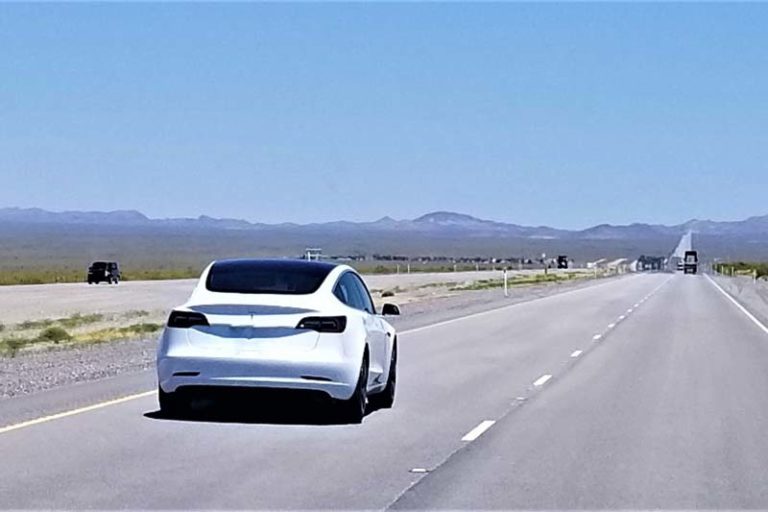 White-Tesla-On-A-Road-Trip